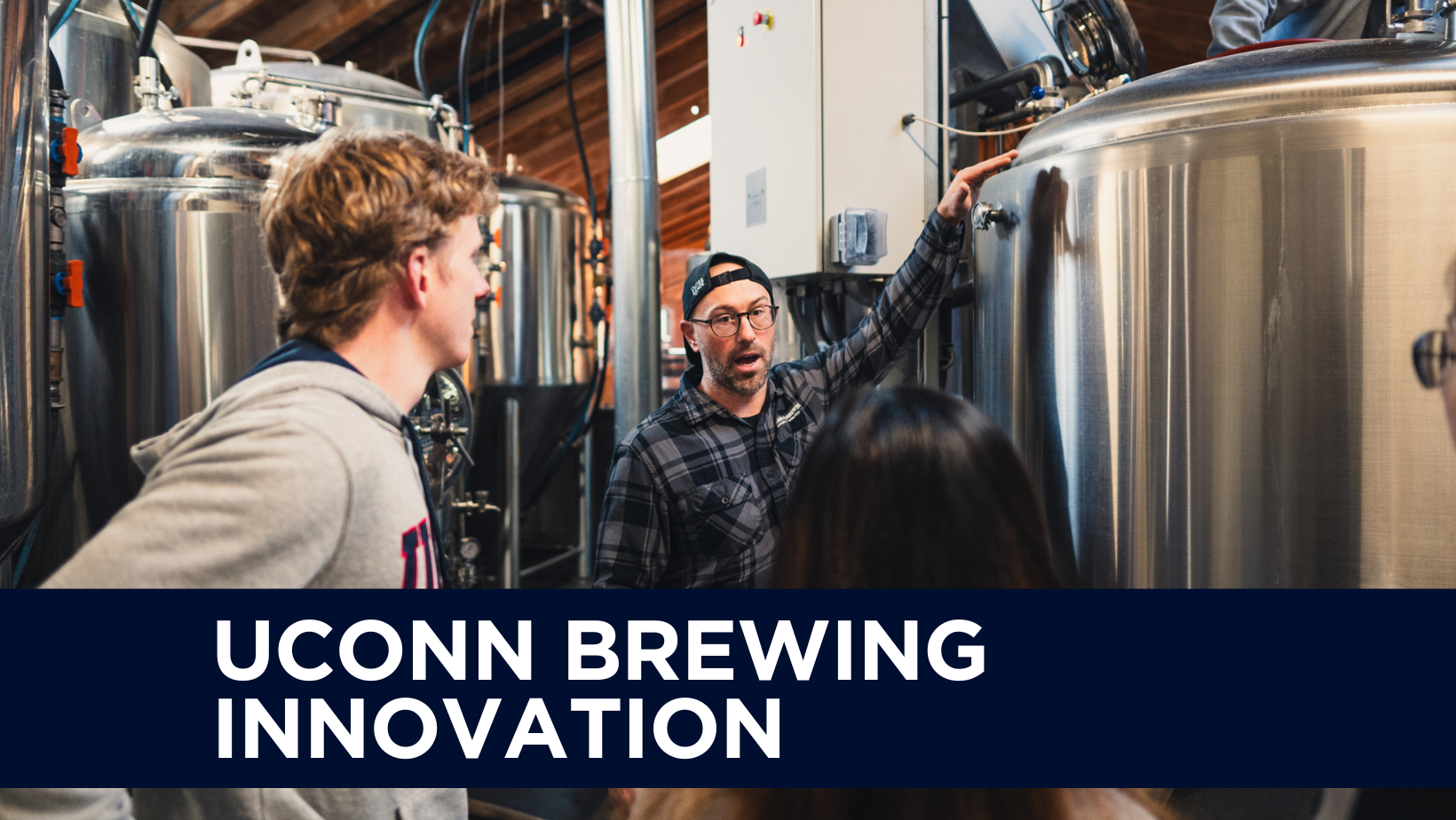 UConn Brewing Innovation text over image of a UConn students learning how to brew by Kinsmen Brewing Co. staff.
